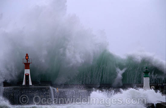 Wave breaking over wall photo