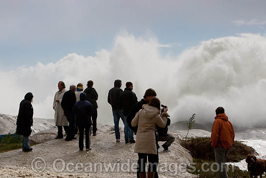 Huge wave breaking over rock photo