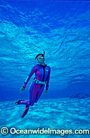 Female Snorkel Diver / Snorkeler in clear blue water. Great Barrier Reef, Queensland, Australia