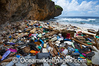 Marine pollution, rubbish trash, garbage comprising of plastic bottles and footwear washed ashore by tidal movement on a remote Christmas Island beach, Indian Ocean, Australia. Drifted from Indonesia.