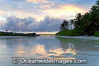 Tropical coconut palm beach and lagoon at sunset. Cocos (Keeling) Islands, Indian Ocean, Australia