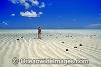 Coastal Seascape with a Girl on a beach sand cay. Heron Island, Great Barrier Reef, Queensland, Australia