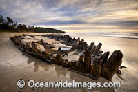 Historic Shipwreck 'Buster' on Woolgoolga beach, New South Wales. Vessel was blown ashore & beached during a violent storm in Feb 1893. Class: Barquentine. Construction: Timber single deck & 3 masts. Built: Nova Scotia, Canada 1884. Length - 129 ft.