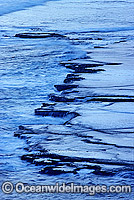 Ocean seascape - water receding off tidal coastal rock platform. Mornington Peninsula, Victoria, Australia