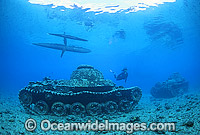 Scuba Diver exploring a wreck of World War II Japanese tanks. New Britain Island, Papua New Guinea.