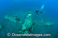 Divers exploring a WWll Japanese Zero fighter plane sitting intact and upright in 17m of water. Kimbe Bay, Papua New Guinea.