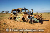 Abandoned old car riddled with bullet holes in outback New South Wales, near Mungo National Park, Australia.