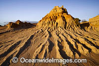 Sunset picture of eroded sand and mud dunes, known as 'Walls of China', situated on the fringe of Lake Mungo. Mungo World Heritage National Park, south-western New South Wales, Australia