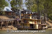 Historic wood fired paddlesteamer, PS Emmylou, cruising down the Murray River at Echuca with historic wharf in background, Victoria, Australia.