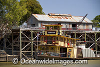 Historic wood fired paddlesteamer, PS Emmylou, cruising down the Murray River at Echuca with historic wharf in background, Victoria, Australia.