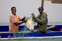 Local fisherman with a Sea Turtle caught in a gill net. Photo taken in Madagascar, near Africa