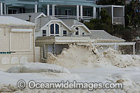 Waves breaking against a coastal house and property during a storm. Cape Town, South Africa