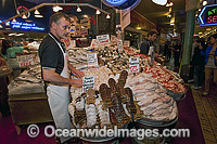 Fishmongers sell seafood at the Pike Place Market in downtown Seattle, Washington, USA.