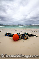 Marine pollution rubbish trash garbage comprising of fishing debris, ropes and floats, washed ashore by tidal movement on a remote tropical island beach. Cocos (Keeling) Islands, Indian Ocean, Australia