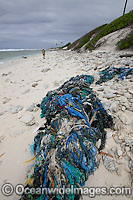 Marine pollution rubbish trash garbage comprising of fishing debris, ropes and nets, washed ashore by tidal movement on a remote tropical island beach. Cocos (Keeling) Islands, Indian Ocean, Australia