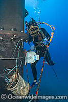 A commercial hard hat diver (MR) working underwater off Oahu, Hawaii, USA.