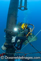 A commercial hard hat diver (MR) welding underwater off Oahu, Hawaii, USA.