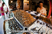 Deep fried Insects on a stick, scorpions, silkworms, beatles, crickets, centipedes and spiders for sale at a food stand in Guangzhou, China.