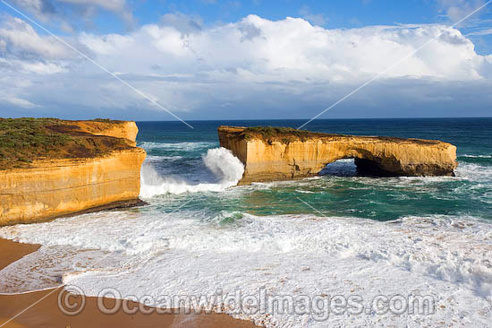 Huge wave crashing over London Bridge, a spectacular sandstone formation carved over time by constant wave action and sea movement. Near Port Campbell, Victoria, Australia Photo - Gary Bell