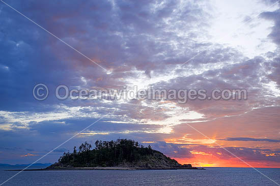 Seascape comprising tropical island and sunset. Whitsunday Islands, Queensland, Australia Photo - Gary Bell