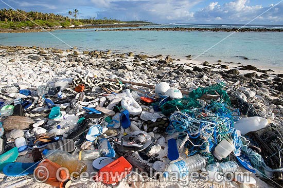 Marine pollution rubbish trash garbage comprising of plastic bottles, footwear and fishing implements washed ashore by tidal movement on a remote tropical island beach - probably drifting in from Indonesia. Cocos (Keeling) Islands, Indian Ocean, Australia Photo - Gary Bell