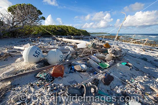 Marine pollution rubbish trash garbage comprising of plastic bottles, footwear and fishing implements washed ashore by tidal movement on a remote tropical island beach - probably drifting in from Indonesia. Cocos (Keeling) Islands, Indian Ocean, Australia Photo - Gary Bell