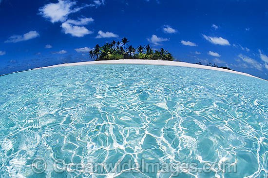 Tropical island setting, comprising coconut palm fringed island surrounded by crystal lagoon water. Cocos (Keeling) Islands, Indian Ocean, Australia Photo - Gary Bell