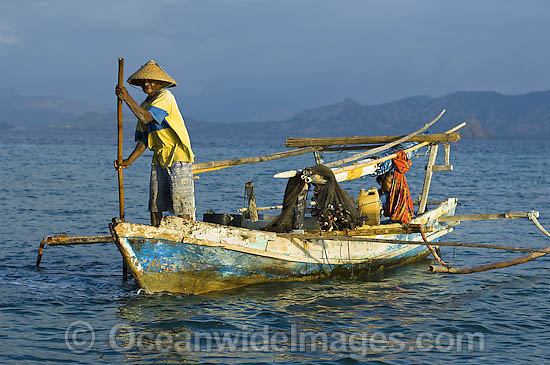 Indonesian fisherman in a traditional fishing boat known as Jukung. Indonesia. Photo - Michael Patrick O'Neill Indonesian fisherman in a traditional fishing boat known as Jukung. Indonesia. Photo - Michael Patrick O'Neill