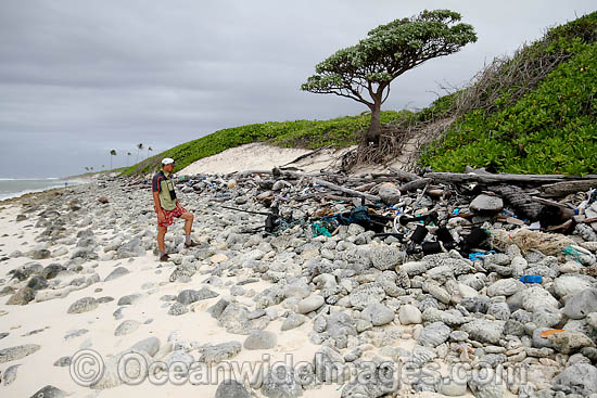 Marine pollution rubbish trash garbage comprising of plastic bottles, footwear and fishing implements, washed ashore by tidal movement on a remote tropical island beach. Cocos (Keeling) Islands, Indian Ocean, Australia Photo - Inger Vandyke Marine pollution rubbish trash garbage comprising of plastic bottles, footwear and fishing implements, washed ashore by tidal movement on a remote tropical island beach. Cocos (Keeling) Islands, Indian Ocean, Australia Photo - Inger Vandyke