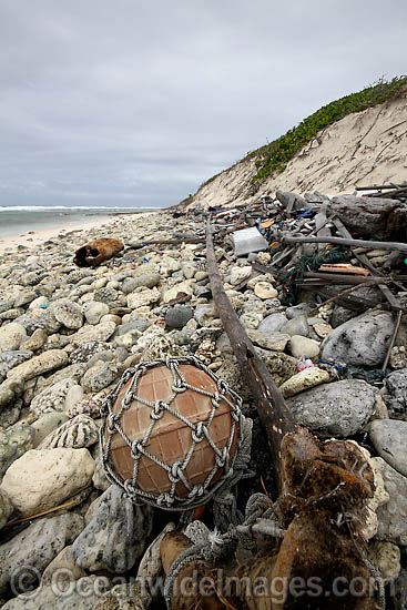 Marine pollution rubbish trash garbage comprising of plastic bottles, footwear and fishing implements, washed ashore by tidal movement on a remote tropical island beach. Cocos (Keeling) Islands, Indian Ocean, Australia Photo - Inger Vandyke Marine pollution rubbish trash garbage comprising of plastic bottles, footwear and fishing implements, washed ashore by tidal movement on a remote tropical island beach. Cocos (Keeling) Islands, Indian Ocean, Australia Photo - Inger Vandyke