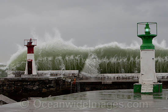 Wave breaking over lighthouse photo