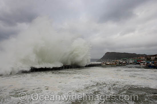 Wave breaking over wall photo