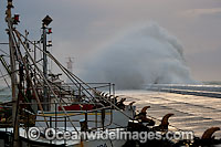 Wave breaking over wall Photo - Chris and Monique Fallows