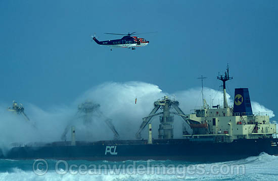 Rescue helicopter airlifting an operations worker from a ship engulfed by a huge breaking wave during a storm. Cape Town, South Africa Photo - Chris and Monique Fallows Rescue helicopter airlifting an operations worker from a ship engulfed by a huge breaking wave during a storm. Cape Town, South Africa Photo - Chris and Monique Fallows