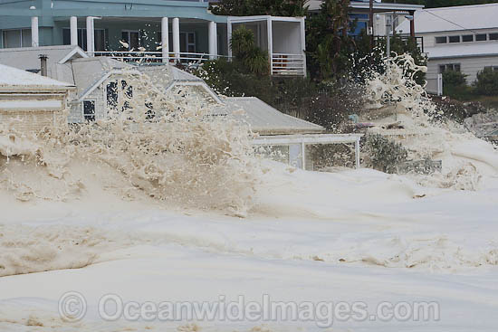 Wave breaking over house photo