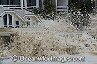 Wave breaking over house Photo - Chris and Monique Fallows