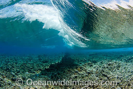 Surf crashing over a coral reef platform Indo Pacific