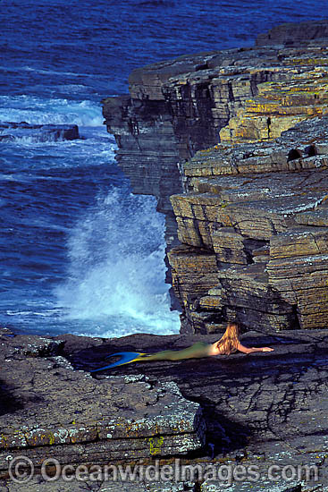 This ocean scene with a Mermaid (MR) resting on a rock platform is a composite image, comprising of 2 or more images digitally merged together. This ocean scene with a Mermaid (MR) resting on a rock platform is a composite image, comprising of 2 or more images digitally merged together.