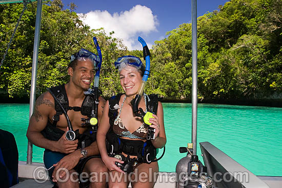 Divers (MR) in scuba gear about to enter the water off a boat in The Rock Islands, Palau, Micronesia. Photo - David Fleetham Divers (MR) in scuba gear about to enter the water off a boat in The Rock Islands, Palau, Micronesia. Photo - David Fleetham