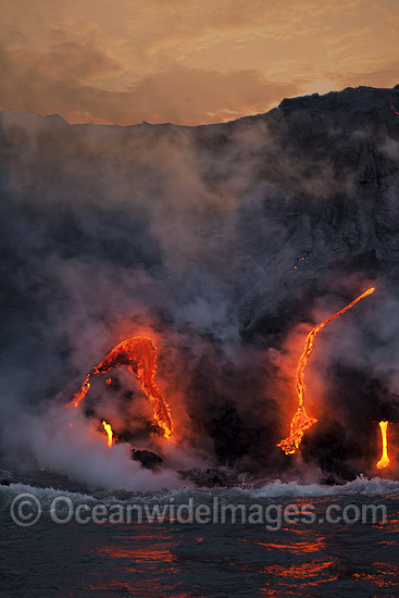 The Pahoehoe lava flowing from Kilauea Volcano has reached the Pacific Ocean at dawn near Kalapana, Big Island, Hawaii. Photo - David Fleetham