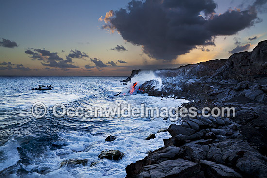 People in a boat observe the Pahoehoe lava flowing from Kilauea Volcano, which has reached the Pacific Ocean near Kalapana, Big Island, Hawaii. Photo - David Fleetham People in a boat observe the Pahoehoe lava flowing from Kilauea Volcano, which has reached the Pacific Ocean near Kalapana, Big Island, Hawaii. Photo - David Fleetham