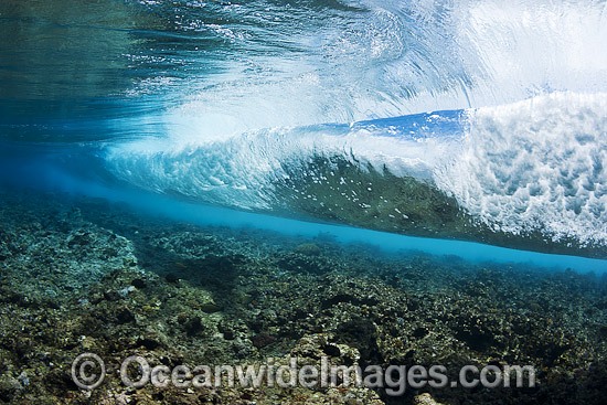 Breaking wave over reef photo