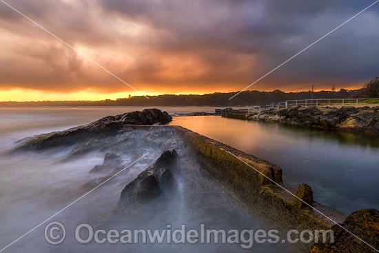 Sawtell Rock Pool at sunset during stormy weather. A favourite natural rock swimming pool open to the general public. Sawtell, New South Wales, Australia. Photo - Gary Bell