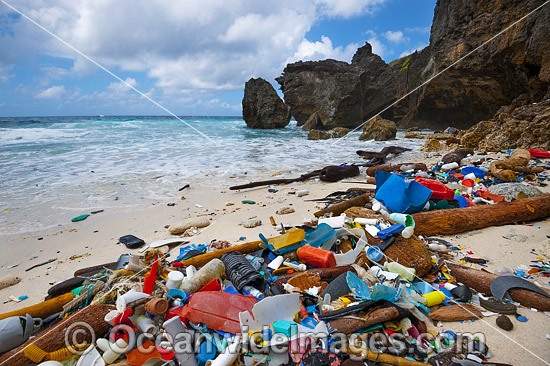 Marine pollution, rubbish trash, garbage comprising of plastic bottles and footwear washed ashore by tidal movement on a remote Christmas Island beach, Indian Ocean, Australia. Drifted from Indonesia. Photo - Gary Bell