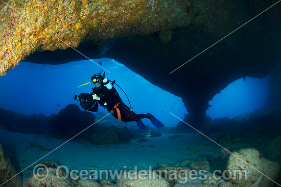 Underwater photographer exploring and photographing a tropical coral reef cave at Christmas Island, Indian Ocean, Australia. Photo - Gary Bell Underwater photographer exploring and photographing a tropical coral reef cave at Christmas Island, Indian Ocean, Australia. Photo - Gary Bell