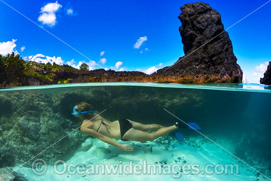 Snorkel diver exploring a tidal rock pool at Christmas Island, Indian Ocean, Australia. Photo - Gary Bell