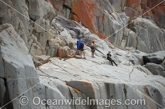 Rock climbers, prepare to climb White Water Wall, located in Freycinet National Park, Tasmania, Australia. Photo - Gary Bell