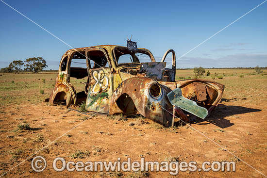 Abandoned old car riddled with bullet holes in outback New South Wales, near Mungo National Park, Australia. Photo - Gary Bell