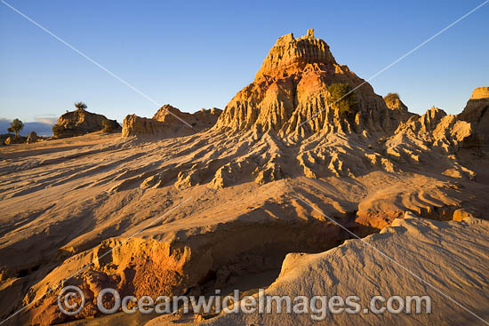 Sunset picture of eroded sand and mud dunes, known as 'Walls of China', situated on the fringe of Lake Mungo. Mungo World Heritage National Park, south-western New South Wales, Australia Photo - Gary Bell