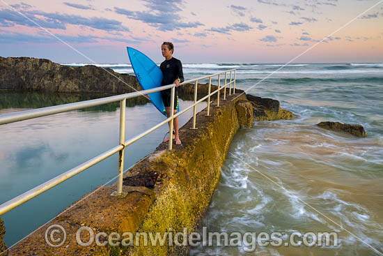 Surfer exiting water at Sawtell Rock Pool. Sawtell, New South Wales, Australia. Photo - Gary Bell